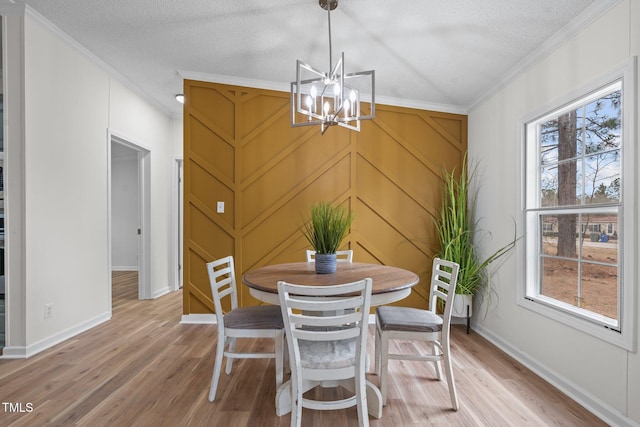 dining space featuring a notable chandelier, plenty of natural light, and light wood-type flooring