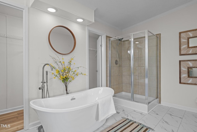 full bathroom featuring marble finish floor, a stall shower, crown molding, and a walk in closet