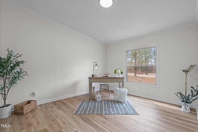 office area with crown molding, wood finished floors, baseboards, and a textured ceiling