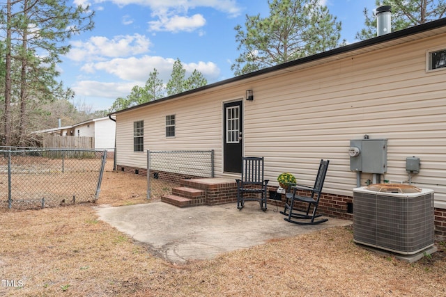 back of property with a patio area, fence, and central AC