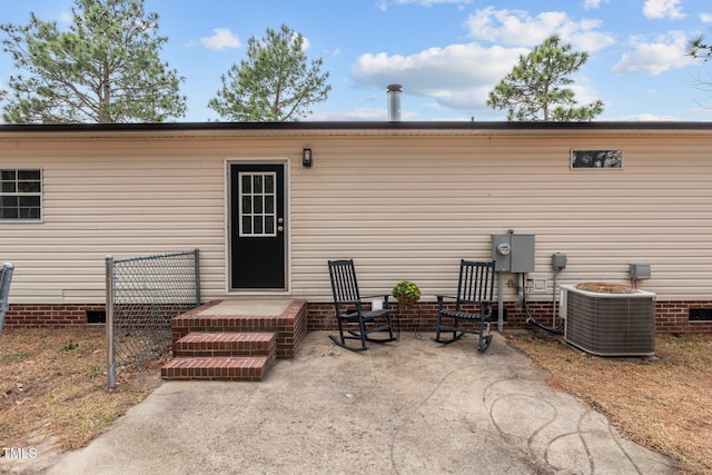 rear view of property with a patio, central AC unit, and crawl space