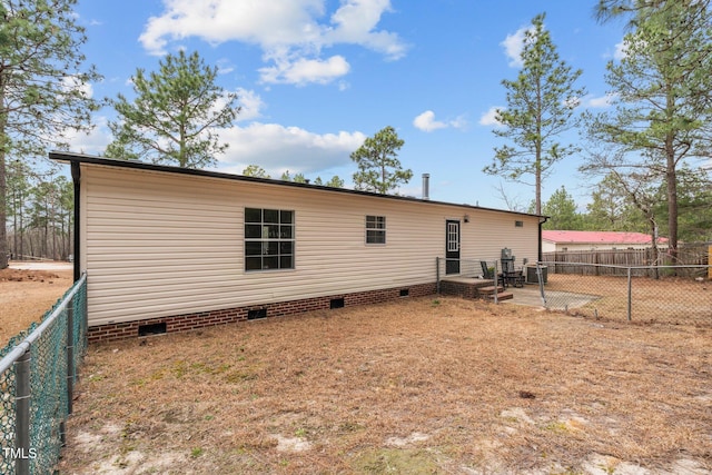 back of property with crawl space, cooling unit, and fence private yard