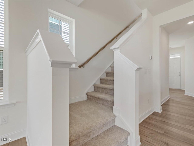 stairs featuring baseboards and wood finished floors