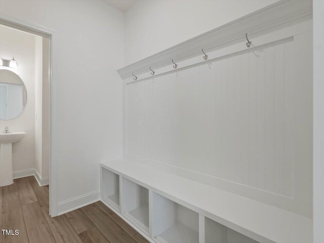 mudroom featuring baseboards and light wood finished floors