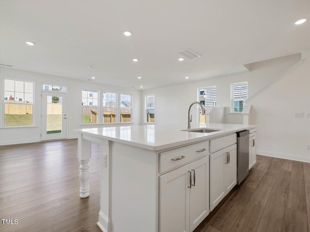 kitchen with dishwasher, light countertops, a wealth of natural light, and a sink