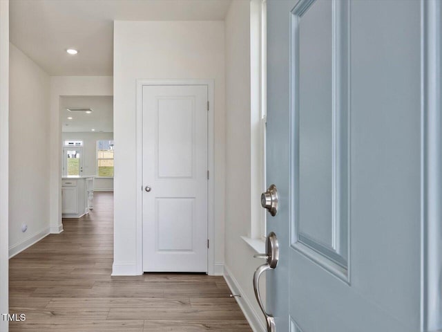 entryway with recessed lighting, baseboards, and light wood-style floors