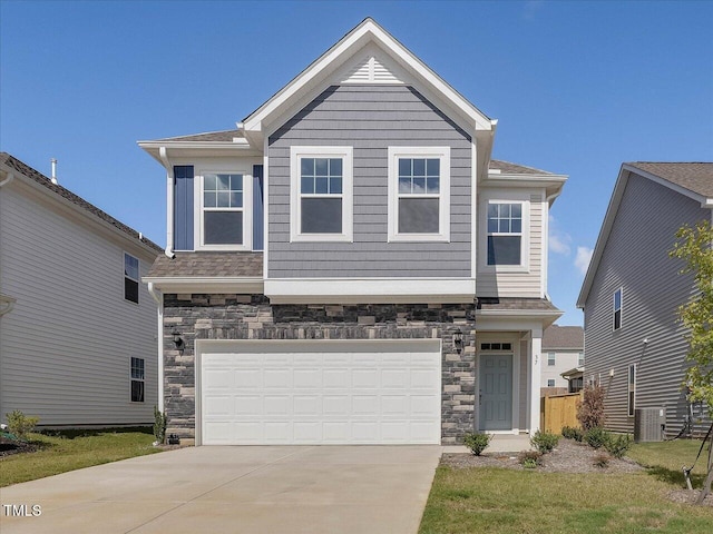 view of front facade featuring concrete driveway, a garage, central AC unit, and stone siding