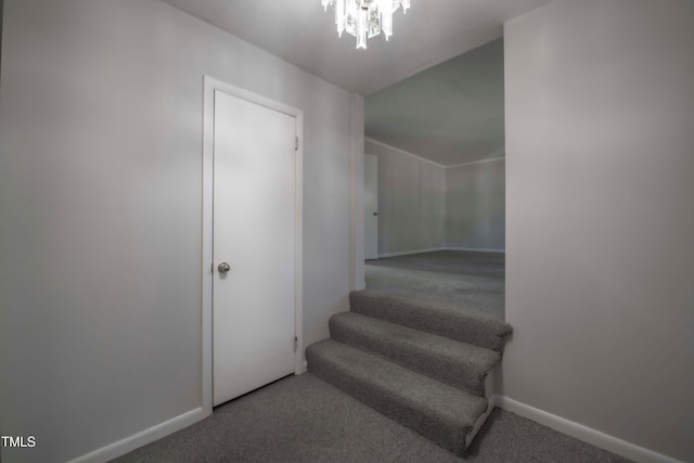 stairs with a chandelier, baseboards, and carpet floors