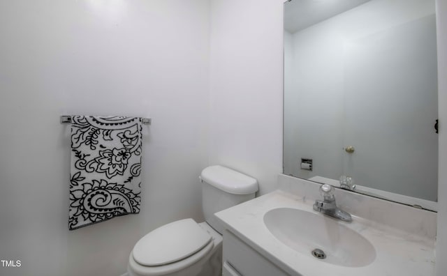 half bathroom with toilet and vanity