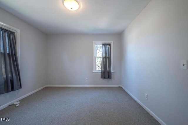 carpeted empty room with baseboards