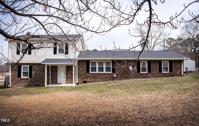 view of front of home with brick siding and a front yard