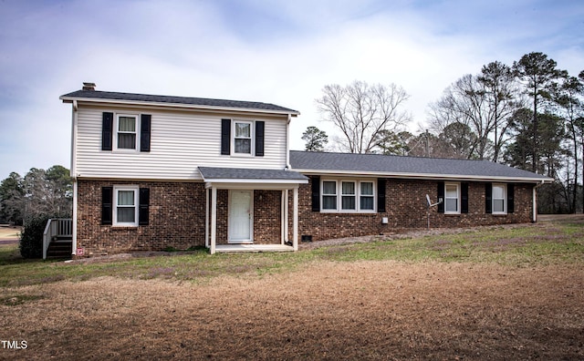 view of front of home with a front yard and brick siding