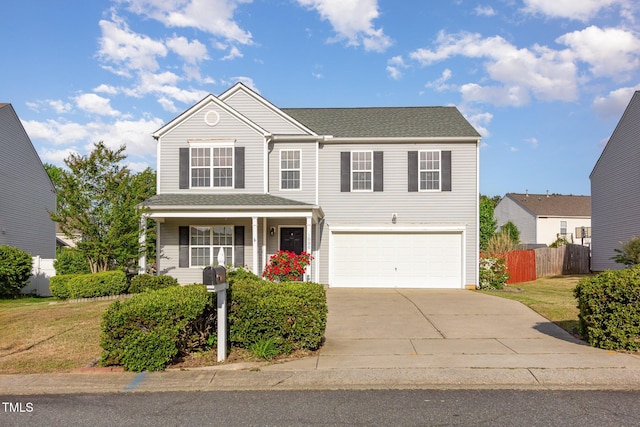1009 Limeberry Ct, Clayton, NC 27520 - traditional-style home featuring concrete driveway, a front lawn, covered porch, fence, and a garage