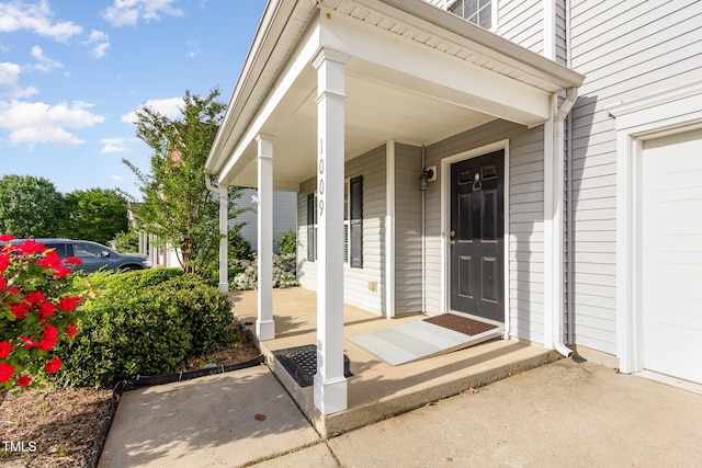 1009 Limeberry Ct, Clayton, NC 27520 - view of exterior entry featuring a garage and covered porch