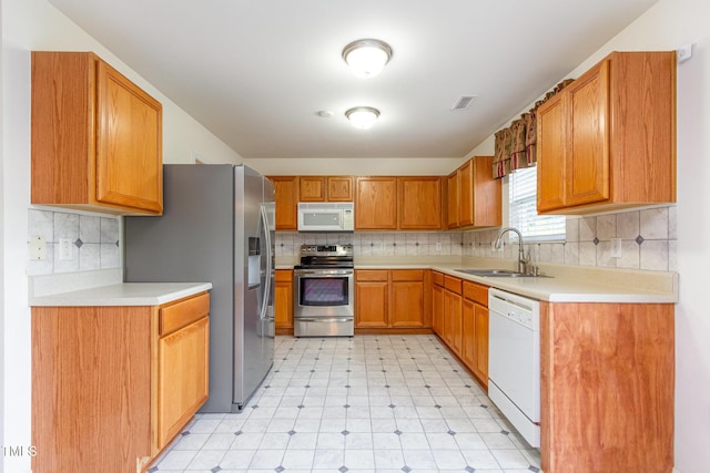 1009 Limeberry Ct, Clayton, NC 27520 - kitchen with light floors, light countertops, appliances with stainless steel finishes, and a sink