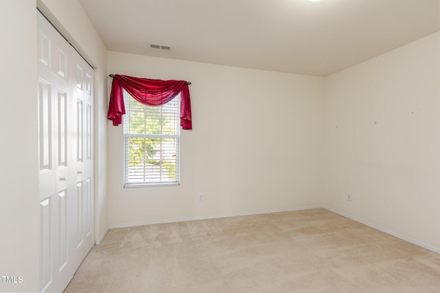 1009 Limeberry Ct, Clayton, NC 27520 - spare room featuring light colored carpet, baseboards, and visible vents