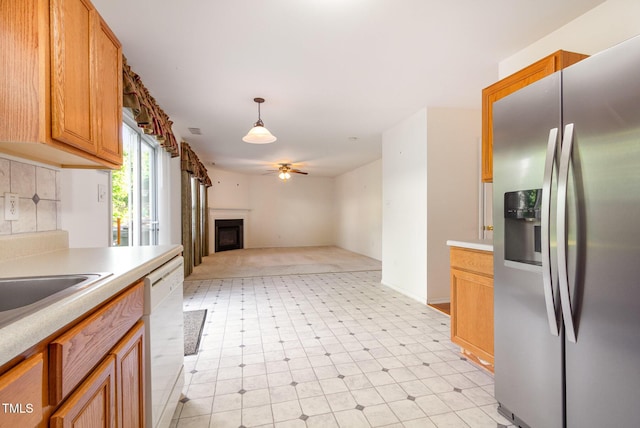 1009 Limeberry Ct, Clayton, NC 27520 - kitchen featuring stainless steel fridge with ice dispenser, light countertops, dishwasher, a fireplace, and ceiling fan