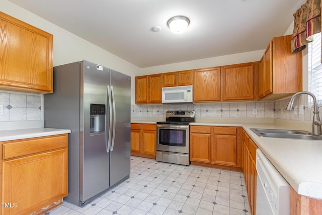 1009 Limeberry Ct, Clayton, NC 27520 - kitchen with light countertops, tasteful backsplash, appliances with stainless steel finishes, and a sink
