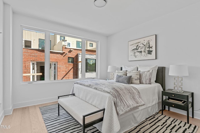 bedroom with baseboards and wood finished floors