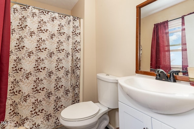 bathroom with vanity, toilet, and a shower with curtain