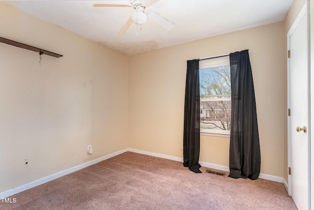 unfurnished room with visible vents, baseboards, light colored carpet, and a ceiling fan