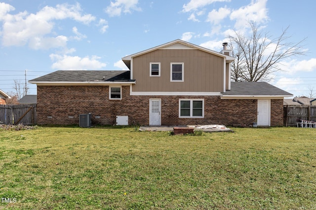 rear view of property featuring a patio, cooling unit, a fenced backyard, a lawn, and brick siding