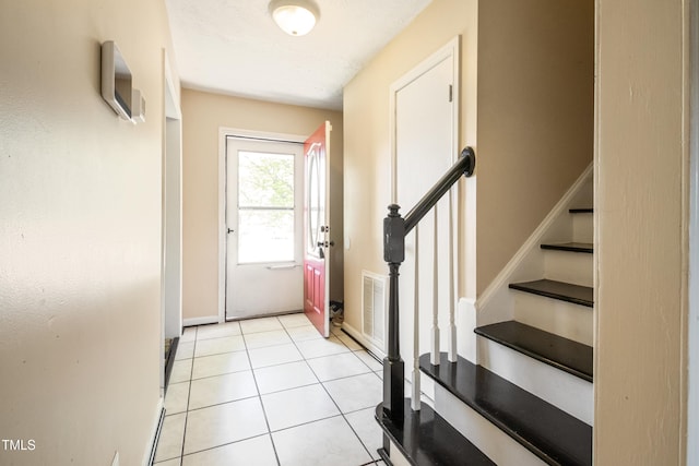 doorway to outside with stairway, baseboards, light tile patterned flooring, and visible vents