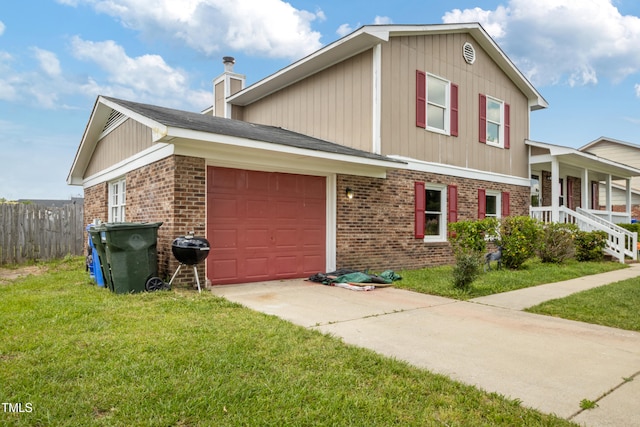 split level home featuring brick siding, an attached garage, driveway, and a front yard