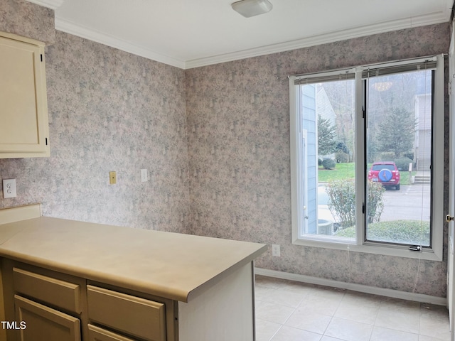 kitchen with baseboards, wallpapered walls, light tile patterned flooring, light countertops, and crown molding