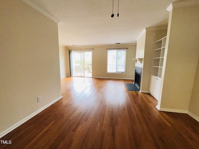 unfurnished living room featuring baseboards, a fireplace with flush hearth, ornamental molding, and dark wood finished floors