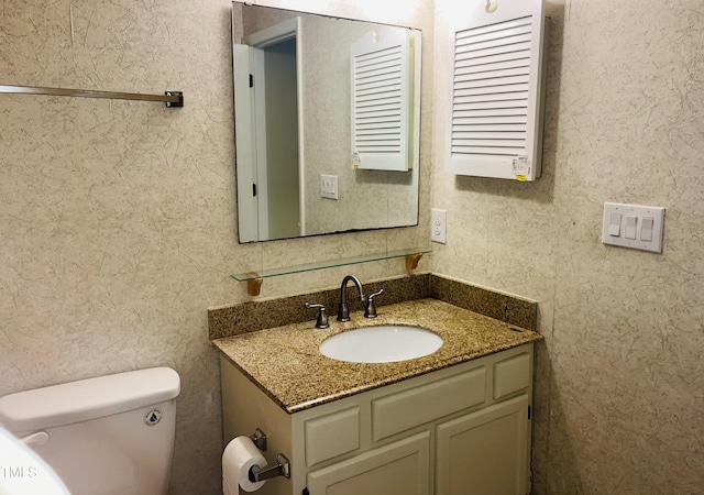 bathroom with toilet and vanity