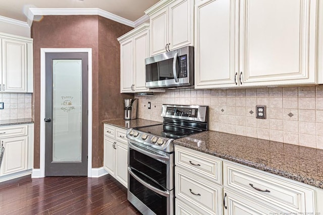 kitchen featuring crown molding, dark stone counters, decorative backsplash, dark wood-style floors, and stainless steel appliances