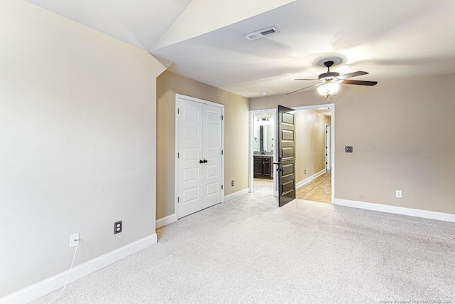 empty room featuring visible vents, light carpet, baseboards, and a ceiling fan