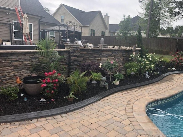 view of patio with a gazebo and fence