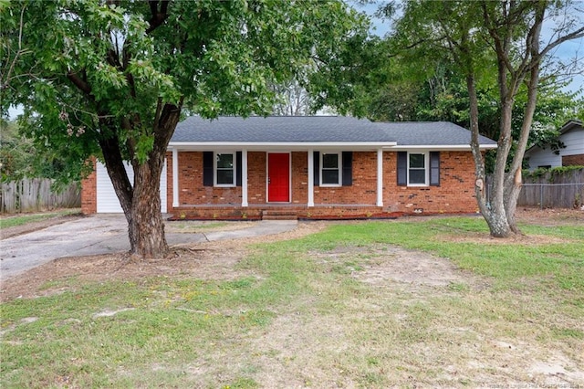 ranch-style house featuring driveway, a front lawn, fence, covered porch, and brick siding