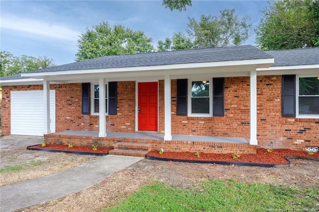 single story home featuring brick siding, a porch, and an attached garage