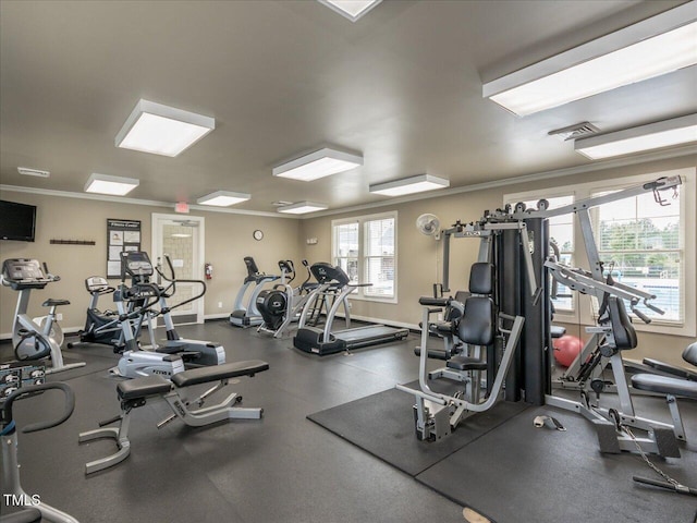 workout area featuring visible vents, baseboards, and ornamental molding