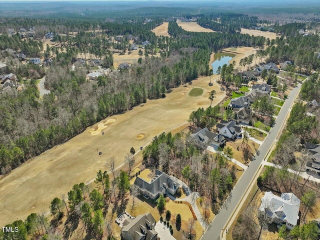 drone / aerial view featuring a wooded view