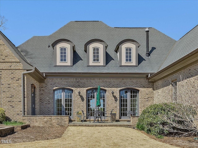 view of front of home featuring french doors and brick siding