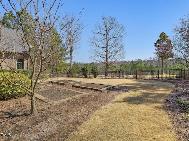 view of yard with a vegetable garden and fence