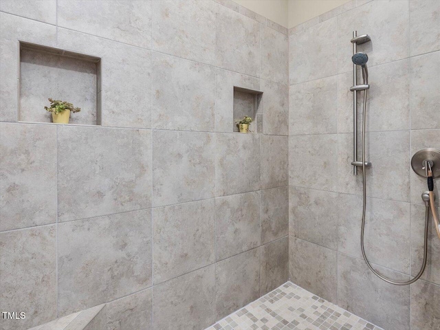 full bath featuring tiled shower