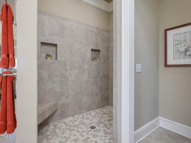 full bath with tile patterned floors, baseboards, and a tile shower