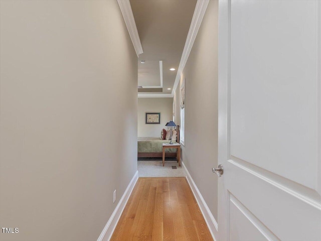 corridor featuring recessed lighting, light wood-style floors, baseboards, and ornamental molding