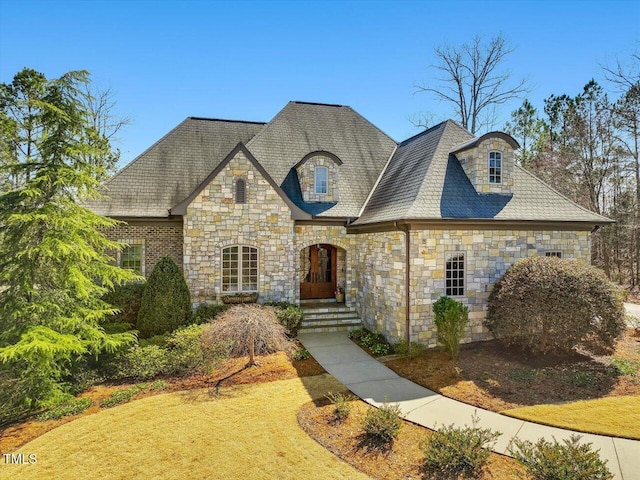 french country inspired facade featuring stone siding