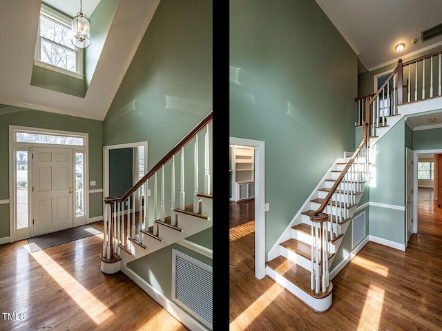 foyer entrance with stairway, wood finished floors, visible vents, and ornamental molding