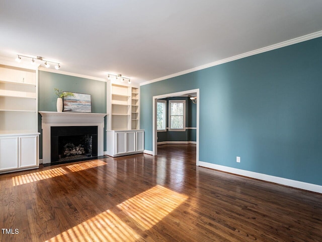 unfurnished living room with a fireplace, crown molding, wood finished floors, and baseboards