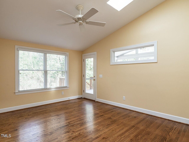 empty room featuring baseboards, dark wood-type flooring, a ceiling fan, and vaulted ceiling