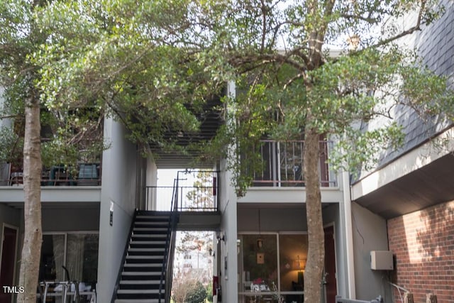 back of house featuring stairway