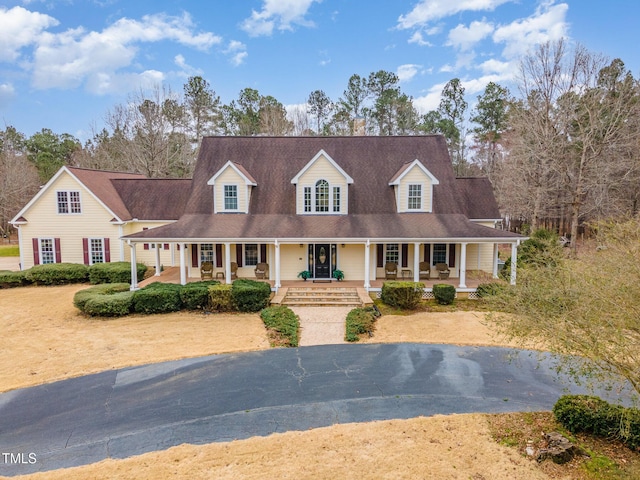 new england style home featuring covered porch