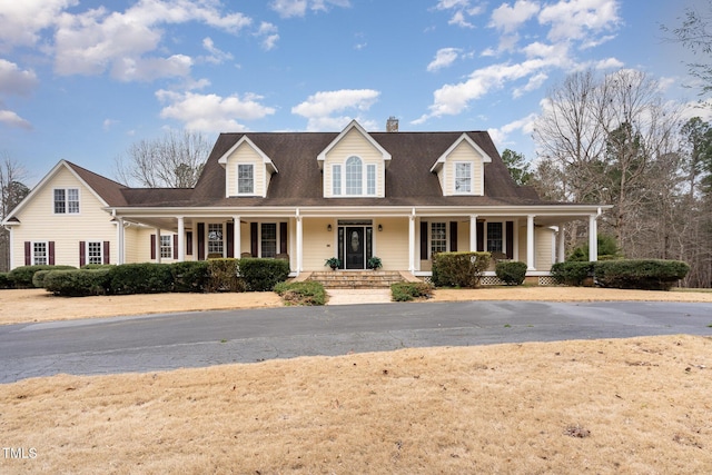 view of front of house with a porch and a chimney